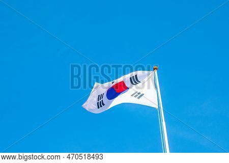 South Korea's Taegeukgi Fluttering In The Wind Under A Blue Sky