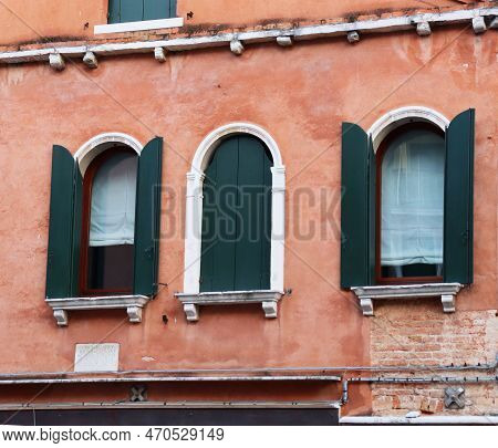 Front Old Red Brick Wall Building With Shutters Window. European Architecture. Vintage Building In V