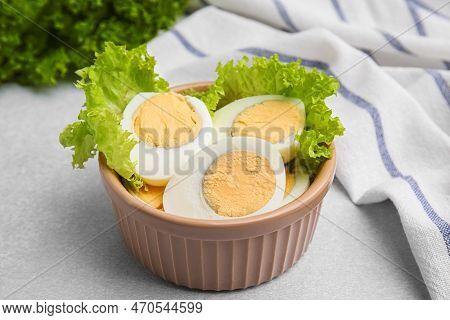 Fresh Hard Boiled Eggs And Lettuce On Light Grey Table