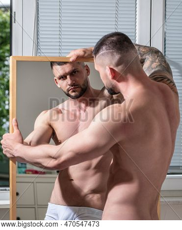 Sexy And Naked Muscular Young Man Posing Indoors. Sexy Shirtless Male Model. Attractive Young Naked 