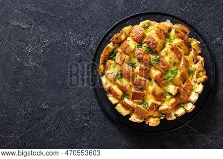 Cheesy Garlic Bread, Pull Apart Whole Round Bread On Black Platter On Concrete Table, Horizontal Vie