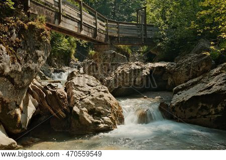Wooden Bridge Over The Seisenbergklamm Gorge In Weissbach Bei Lofer, Austria With Jagged Rocks Aroun