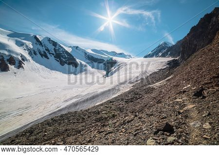 Scenic Mountain Landscape With Large Glacier In Sunlight. Awesome Scenery With Glacial Tongue Under 