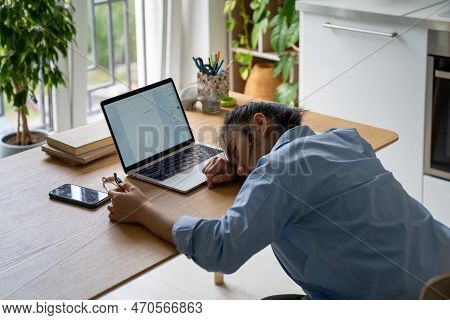 Creative Burnout. Exhausted Girl Copywriter Writer Lying On Desk With Laptop, Having No Motivation A