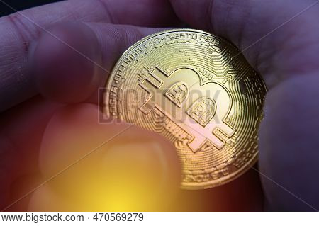 Finger Hold Bitcoin Golden On Black Isolated. Hand Hold Gold Bitcoin Crypto Ditital Money Concept. O