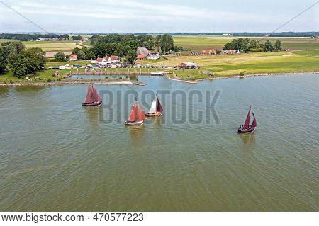 Aerial From Traditional Dutch Wooden Boats At The Ijsselmeer Near The Harbor From Laaxum In Frieslan