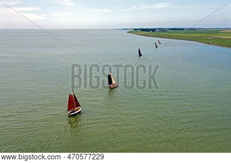 Aerial From Traditional Dutch Wooden Boats At The Ijsselmeer Near The Harbor From Laaxum In Frieslan