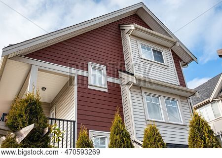 Top Of A House With Nice Windows. Dormer In The Blue Sky Background. Beautiful Home Exterior. Real E