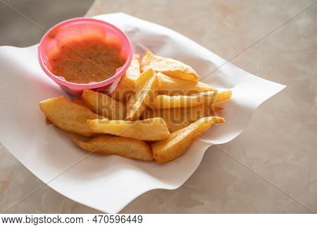 Khao Ram Fuen Tod Served On Table With Sauce. This Food Commonly Eaten Amongst The Thai Yai In The C