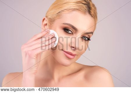 Woman Cleaning Face With A Cotton Pad. Skincare, Cotton Pad And Woman Cleaning Face On Studio Backgr