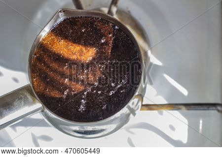 Barista Preparing Hot Tasty Drink From Copper Turk, Boils Water For Coffee On Small Fire In Cezve. C