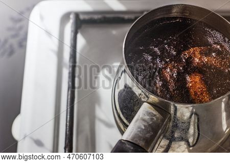 Barista Preparing Hot Tasty Drink From Copper Turk, Boils Water For Coffee On Small Fire In Cezve. C