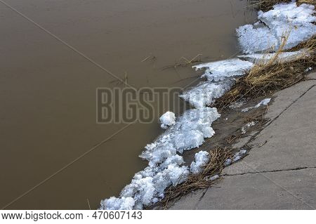 Spring Ice Drift On The River In Muddy Water Before High Water And Flood, Front And Background Blurr