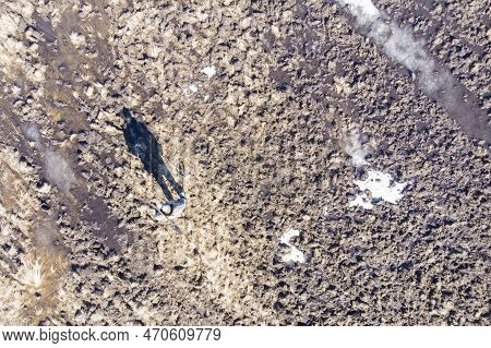 Man On A Treasure Hunt With A Metal Detector In The Woods On The Field, Photographed From A Drone, B