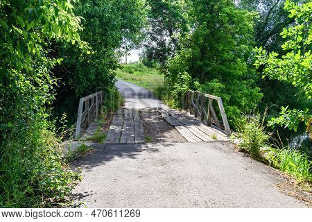 Beautifully Standing Old Wooden Bridge Over River In Colored Background Close Up
