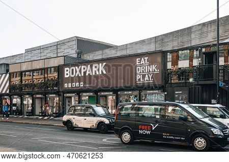 London, Uk - February 09, 2023: Cars And Taxi In Front Of Shops At Boxpark Shoreditch, London, Shipp