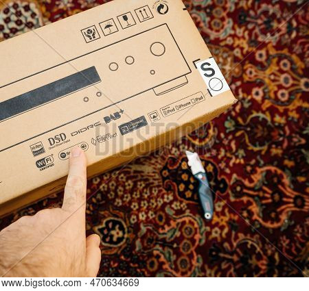 Paris, France - Dec 13, 2022: Pov Male Hand Pointing To Spotify Dsd On The Cardboard Package Of New 