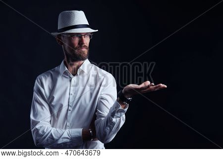 Serious Middle Age Man In White Shirt And Hat Showing Blank Copy Space On His Palm