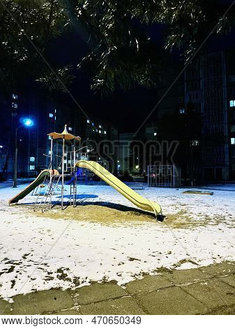 Colorful Children's Slides In Winter Late In The Evening