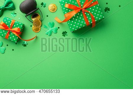 Saint Patrick's Day Concept. Top View Photo Of Green Present Boxes With Orange Ribbon Bows Pot With 