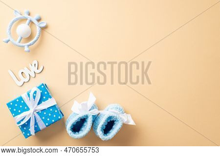 Baby Shower Concept. Top View Photo Of Blue Present Box With Bow Inscription Love Knitted Shoes And 