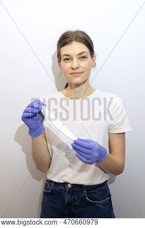 Caucasian Manicurist, Nail Technician Holds File In Hands, Wearing Gloves. White Smiling Manicure Ma