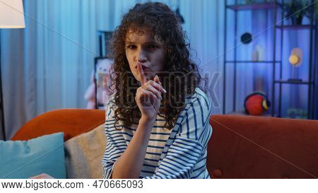 Shh Be Quiet, Hush Please. Young Woman With Curly Hairstyle Presses Index Finger To Lips Makes Silen