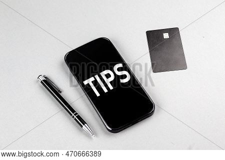 Tips Word On A Smartphone With Credit Card And Pen