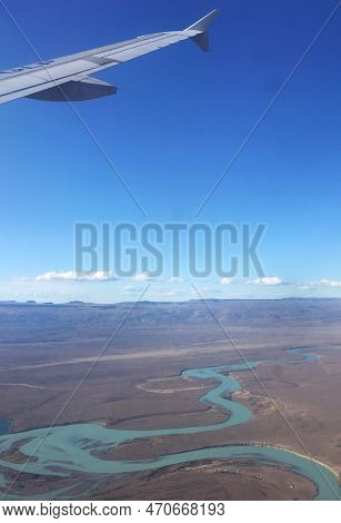 View Of A Blue River With Many Bends During A Plane Trip To Chile During The Holidays. We See Part O