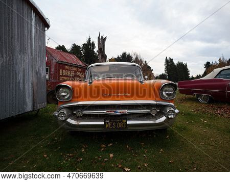 Burkes Pass, New Zealand - 2023: Old Historic Vintage Retro Orange Classic Car In Burkes Pass Villag