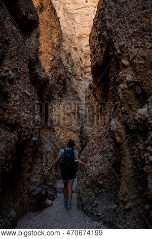 Hiker Slows Down To Admire The Walls Of Sidewinder Canyon In Death Valley National Park