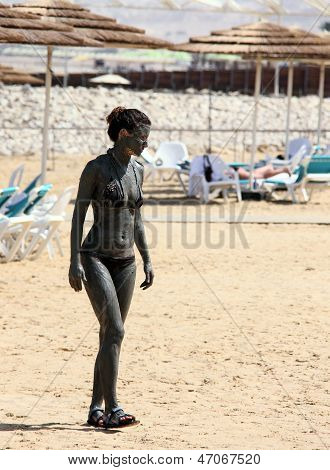 Young Caucasian  Woman Taking Mud Treatment on Dead sea beach