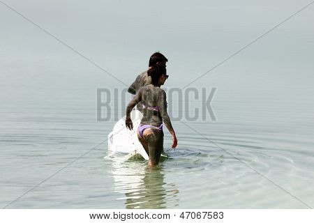 Young Caucasian  Couple Taking Mud Treatment Outdoor
