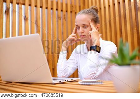 Image Of Sad Tired Stressed Ill Woman Wearing White Shirt Using Laptop While Sitting At Cafe And Wor