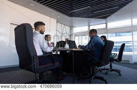 Silhouettes Of People Sitting At The Table. Team Of Young Business People Working And Communicating 