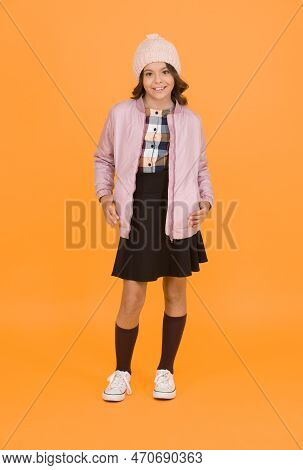Cool Girl. Happy Child Yellow Background. Warm Clothes For Cold Season. Fashionable Girl Looks Like 