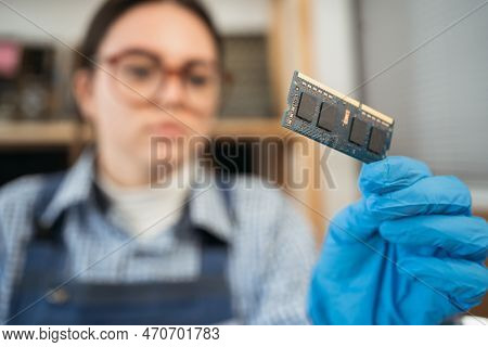 Laptop Memory Module In Woman Hands. Important Computer Component, Close Up. Electronic Repair Shop,