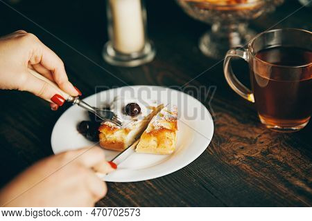 Close Up Image Of A Woman Eating Cherry Pastries With Fork And Knif In Cafe