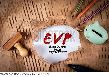 Evp, Executive Vice President. Piggy Bank, Stamp And Colored Pencils On Torn Paper Background