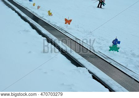 Children\'s Lift Solved With A Plastic Belt. The Child Steps Onto The Belt And Rides Up The Hill. Co