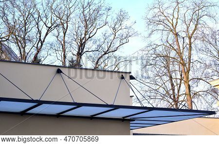 Glass Shelter By A Beige Historical Building. Attached To The Facade Of The Wall In A Metal Frame Su