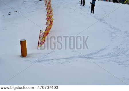 Fencing With A Plastic Mobile Fence On The Downhill Track In The Ski Resort. Protection Against Aval