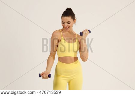 Sporty Woman In Yellow Sport Suit Doing Exercises With Dumbbells Isolated White Background.