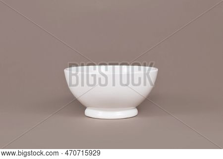 Single Empty Cereal Bowl On Brown Background
