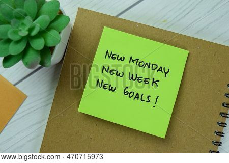Concept Of New Monday, New Week, New Goals Write On Sticky Notes Isolated On Wooden Table.