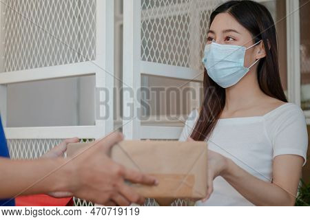 Young Asian Woman, Client Wearing Face Mask While Lockdown, Quarantine Of Covid 19 At Door, Accept D