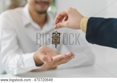 Hand Of House, Apartment Agent Or Realtor Holding Key Giving Young Man New Landlord, Tenant Or Rente