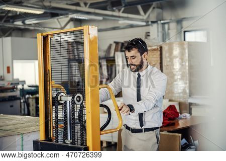 A Headman Using Forklift For Transport At Printing Shop.