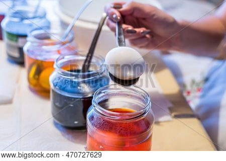 Easter Eggs Color At Home In The Kitchen With Cucumber Glasses And Various Colors, Germany