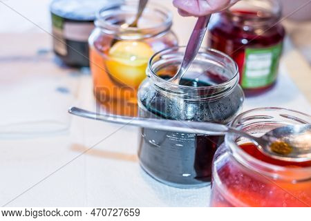 Easter Eggs Color At Home In The Kitchen With Cucumber Glasses And Various Colors, Germany